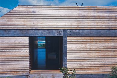 The timber-clad home frames spectacular views of Merimbula.